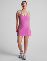 pink mini length dress with a front V neckline, back keyhole detail, contrast binding at neckline and arm openings, and interior bodysuit with pockets.